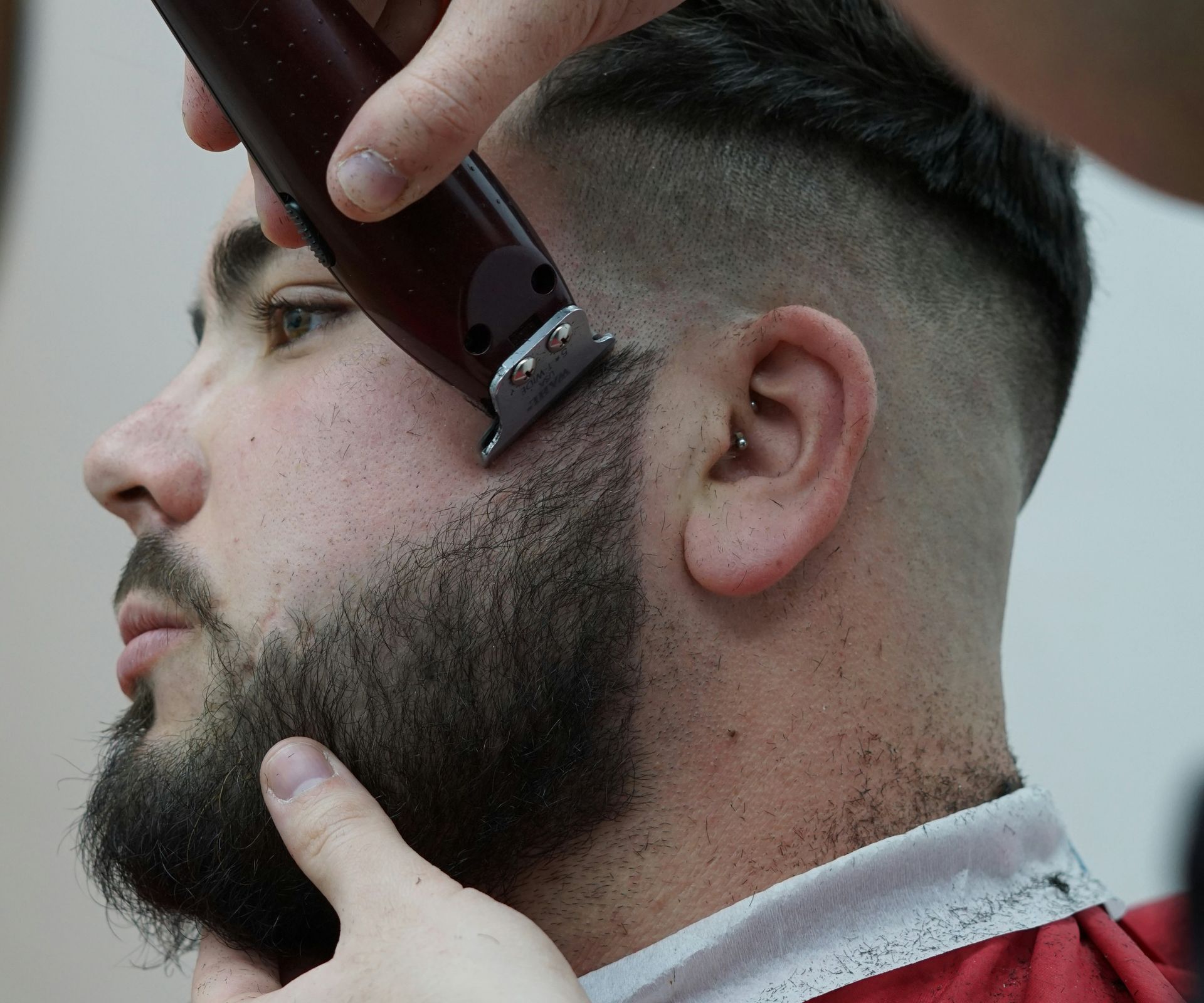 a man getting his hair cut by a barber